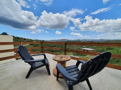 two chairs and a table on a patio with a view at Ventura 2 in Estancia Vieja