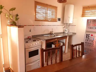 a kitchen with a sink and a stove top oven at Ventura 2 in Estancia Vieja