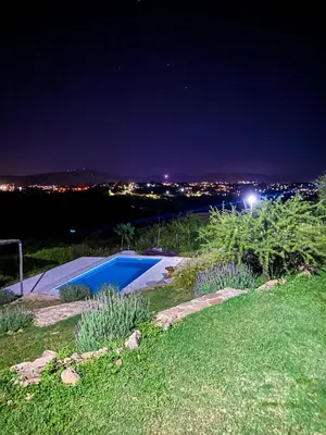 a yard with a swimming pool at night at Ventura 2 in Estancia Vieja