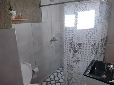 a bathroom with a shower with a toilet and a sink at El Colibrí de los Molles in Los Molles