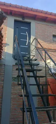 a set of stairs leading to a blue door at El Colibrí de los Molles in Los Molles