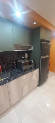 a kitchen with a sink and a refrigerator at Depto Alta Gracia, 1 cuadra del centro- 75m2 in Alta Gracia
