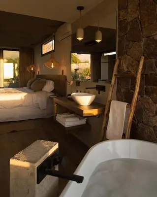 a bathroom with a bed and a bath tub in a room at La Singladura in La Población