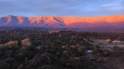 an aerial view of a mountain range with trees and buildings at La Singladura in La Población