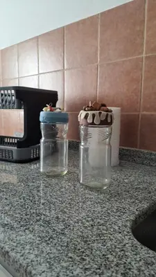 two glass jars sitting on a kitchen counter at Cordoba Costanera 2 dormitorios con estacionamiento in Cordoba