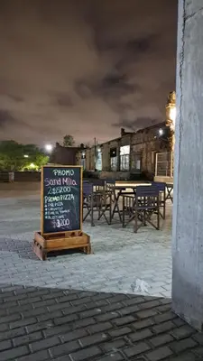 a sign in front of a restaurant at night at Cordoba Costanera 2 dormitorios con estacionamiento in Cordoba
