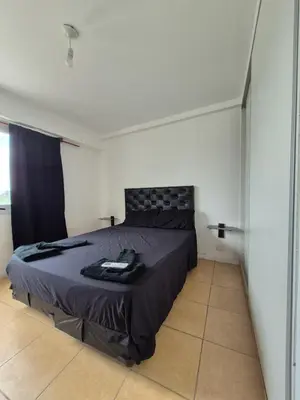 a bedroom with a large bed in a room at Cordoba Costanera 2 dormitorios con estacionamiento in Cordoba