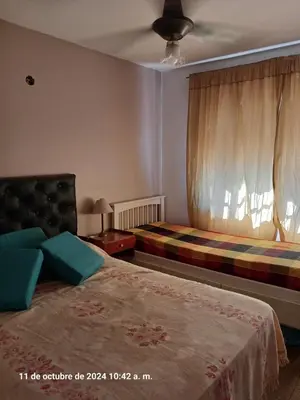a bedroom with two beds and a window at CASA FRENTE AL RIO CON PILETA PRIVADA ESTANCIA VIEJA Carlos Paz in Villa Carlos Paz