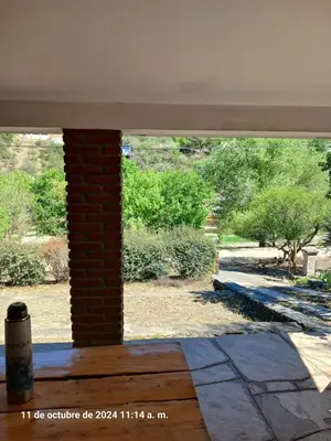 a window in a room with a view of a yard at CASA FRENTE AL RIO CON PILETA PRIVADA ESTANCIA VIEJA Carlos Paz in Villa Carlos Paz