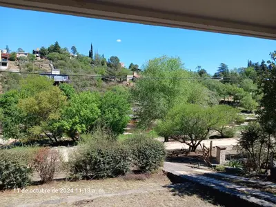 a view from a window of a park with trees at CASA FRENTE AL RIO CON PILETA PRIVADA ESTANCIA VIEJA Carlos Paz in Villa Carlos Paz