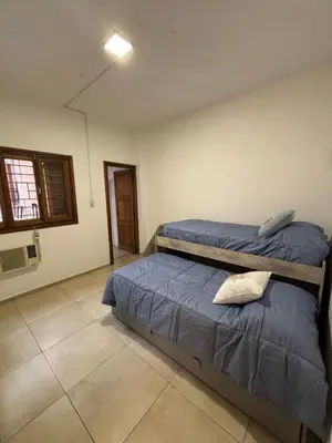 a bedroom with two beds and a window at Casa en Nueva Córdoba con Patio y Asador in Cordoba