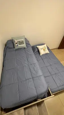 a blue bed with two pillows on top of it at Casa en Nueva Córdoba con Patio y Asador in Cordoba