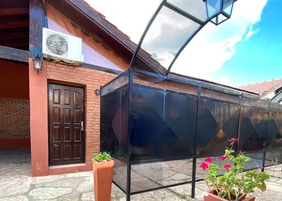 a building with a glass door and some plants at La Cantata in Merlo