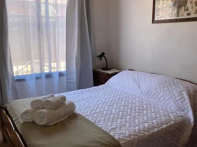 a bedroom with a bed with towels on it at La Cantata in Merlo