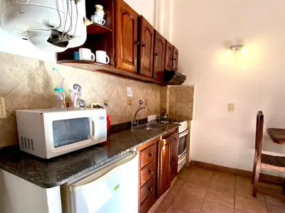 a kitchen with a microwave and a sink at La Cantata in Merlo