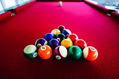a pile of billiard balls on a pool table at Cabañas El Principio in Villa Cura Brochero