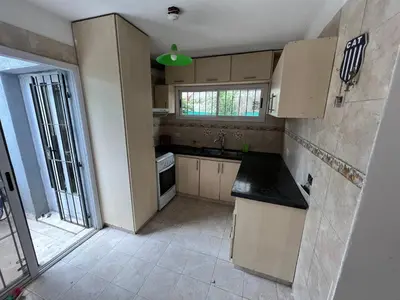 a kitchen with white cabinets and a green light at La Armonía in Potrero de Garay