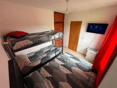 a bedroom with two bunk beds in a room at La Armonía in Potrero de Garay