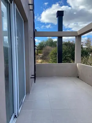 an empty balcony with a large window and a cross at Casa Cabalango in Cavalango