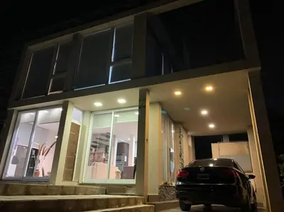 a car parked in front of a house at night at Casa Cabalango in Cavalango