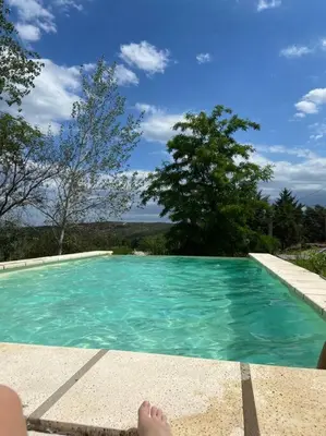 a person laying on the edge of a swimming pool at Casa Cabalango in Cavalango