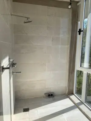 a shower stall in a bathroom with a window at Casa Cabalango in Cavalango