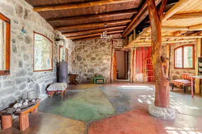 a large room with a stone building with a tree in it at Habitaciones individuales en La Llave in San Javier