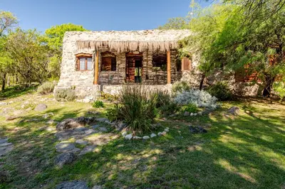 an old stone house in the middle of a yard at Habitaciones individuales en La Llave in San Javier