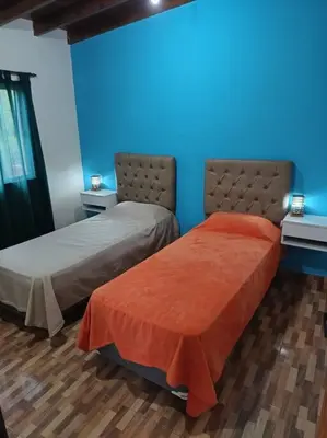 two beds sitting next to each other in a room at Cabañas Los Ranqueles in Merlo