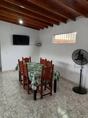 a dining room with a table and chairs and a fan at Cabañas Los Ranqueles in Merlo