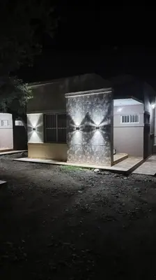 a building at night with lights on it at Cabañas Los Ranqueles in Merlo