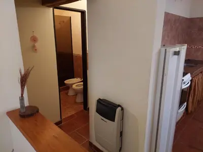 a kitchen with a refrigerator and a bathroom with a toilet at CABAÑA Aguadita Tanti in Tanti