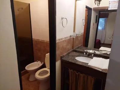 a bathroom with a toilet and a sink and a mirror at CABAÑA Aguadita Tanti in Tanti