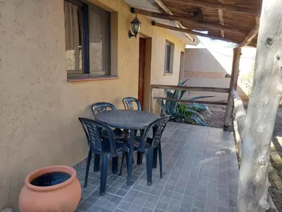 a table and chairs on the patio of a house at CABAÑA Aguadita Tanti in Tanti
