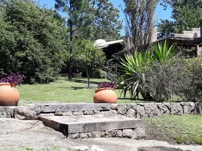 two flower pots sitting on top of a stone bench at CABAÑA Aguadita Tanti in Tanti