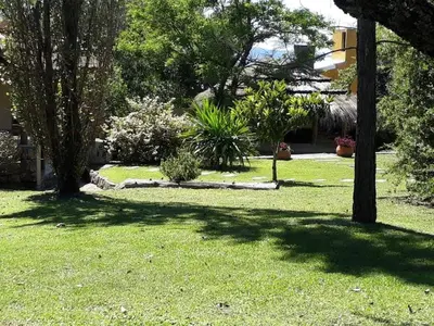 a yard with trees and plants in the grass at CABAÑA Aguadita Tanti in Tanti