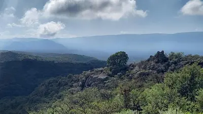 a mountain with a tree on top of it at El Principio Palace in Villa Cura Brochero