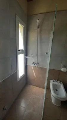 a bathroom with a shower and a toilet and a sink at El Principio Palace in Villa Cura Brochero
