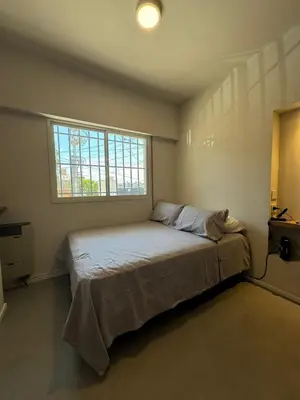 a bedroom with a large bed with a window at Nori Boutique Apartment in Villa Carlos Paz