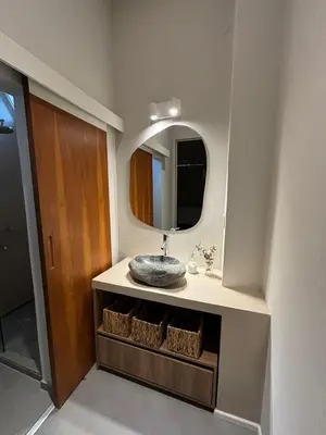 a bathroom with a sink and a mirror at Nori Boutique Apartment in Villa Carlos Paz