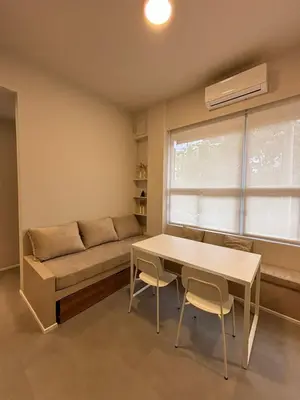 a living room with a couch and a table and chairs at Nori Boutique Apartment in Villa Carlos Paz