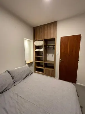 a bedroom with a bed and a closet at Nori Boutique Apartment in Villa Carlos Paz