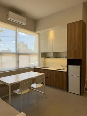 a kitchen with a table and two chairs and a table at Nori Boutique Apartment in Villa Carlos Paz