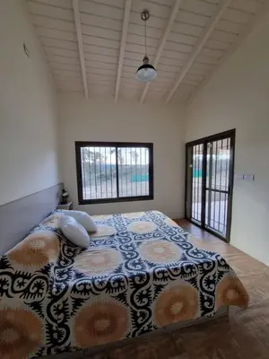 a bedroom with a large bed with pillows on it at Chalet REMANSO DE PAZ in Los Reartes