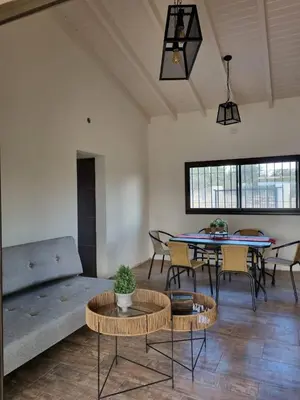 a living room with a couch and a table at Chalet REMANSO DE PAZ in Los Reartes