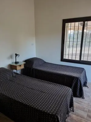 a room with two beds and a window at Chalet REMANSO DE PAZ in Los Reartes