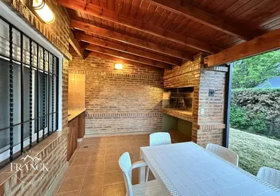 a dining room with a table and chairs on a patio at FINCA FRANCK - Hospedaje de Montaña in Los Reartes