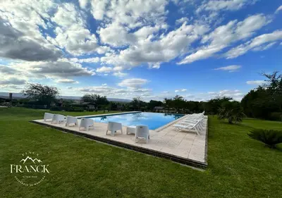a swimming pool with white lounge chairs and a sky at FINCA FRANCK - Hospedaje de Montaña in Los Reartes