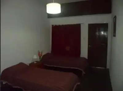 a bedroom with two beds and a window at Complejo Luluara in Villa Carlos Paz