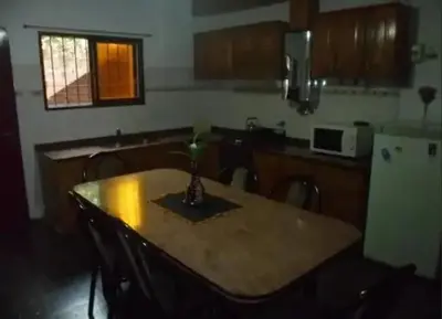 a kitchen with a table with a vase on it at Complejo Luluara in Villa Carlos Paz